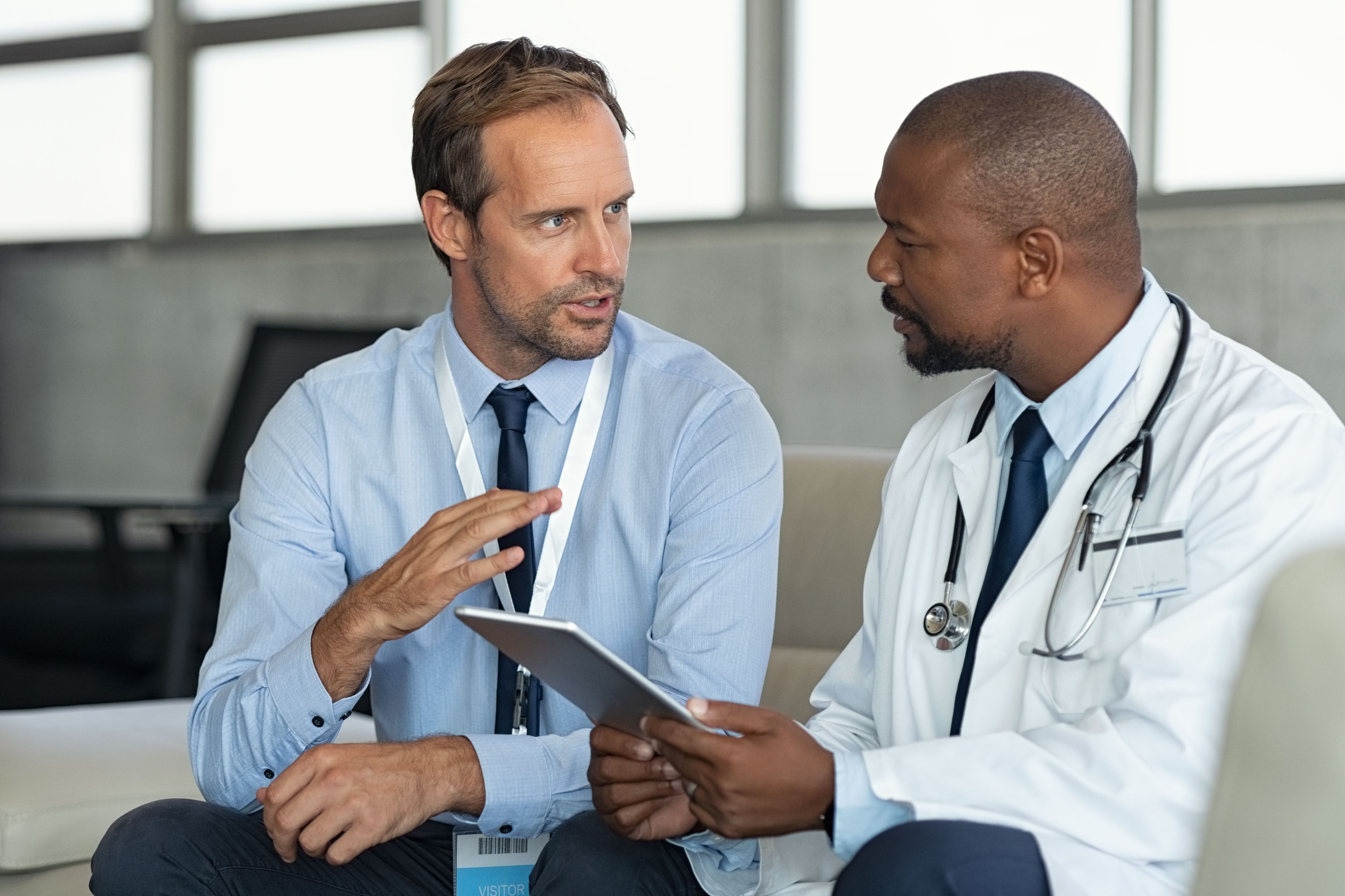 Doctor and executive speaking