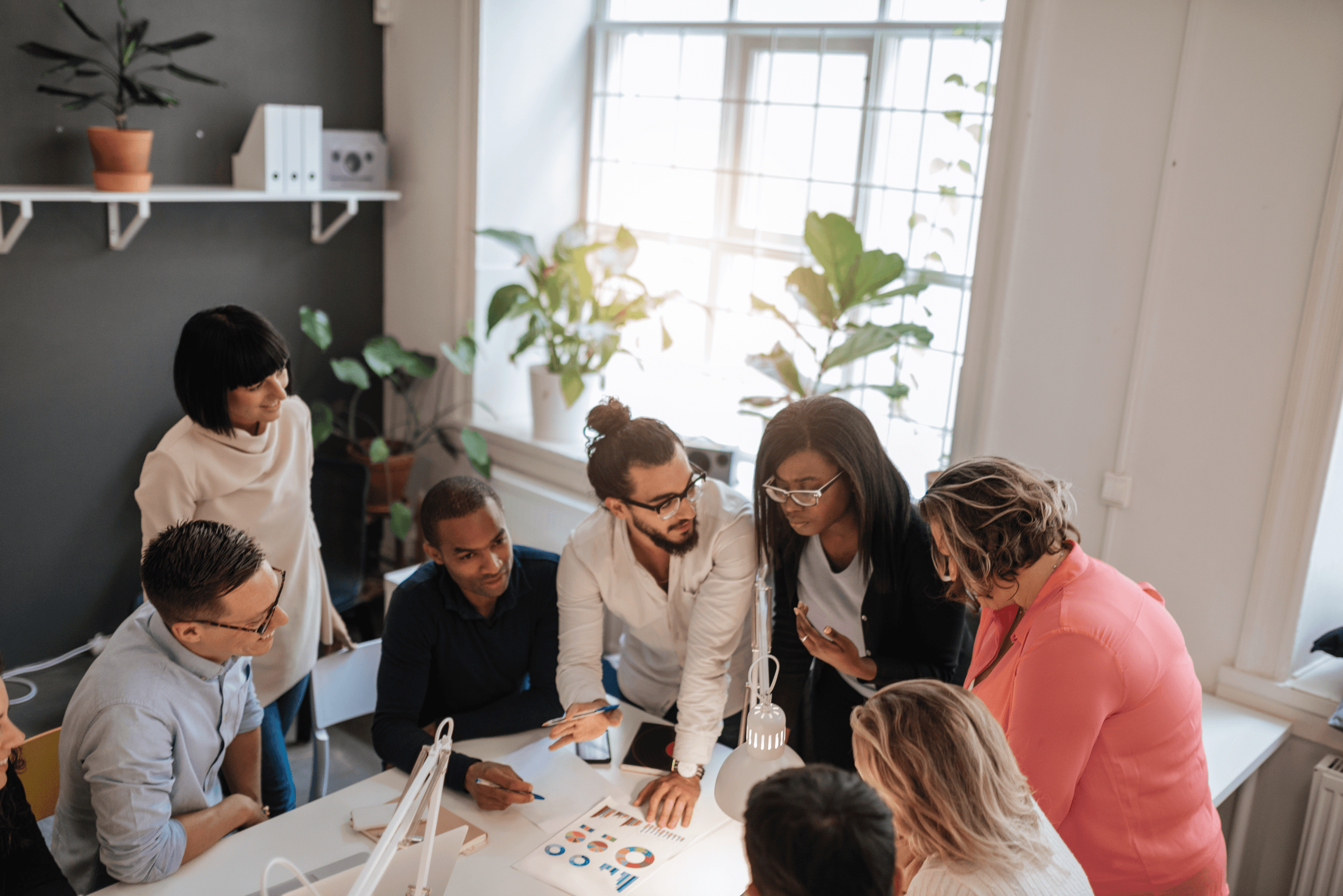 Executive team seated around a conference table in discussion with a new leader
